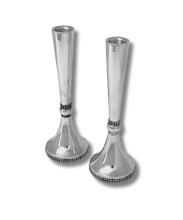 Front view of two large sterling silver candlesticks with filigree design, standing upright