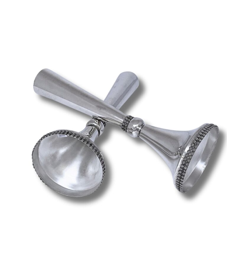 Bottom angle view of the candlesticks lying down, highlighting polished interior and filigree detail