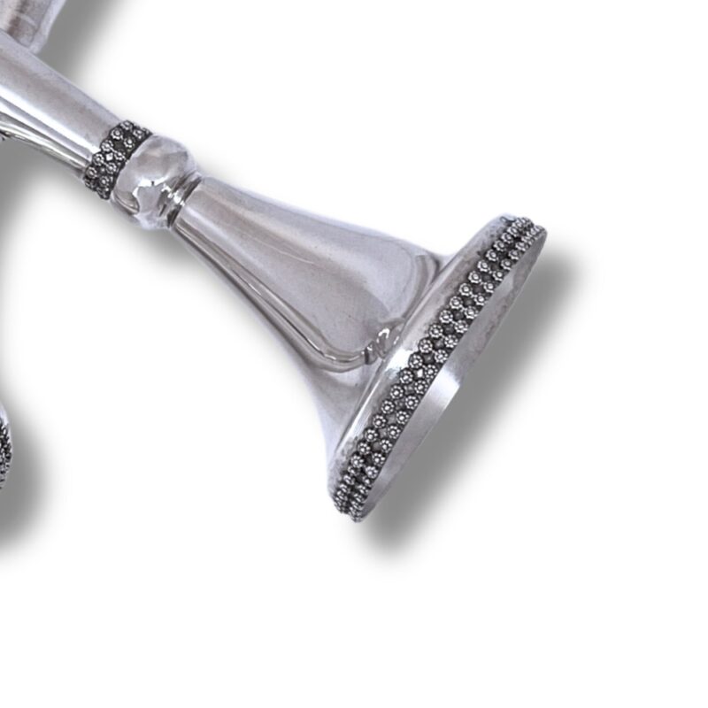 Close-up of filigree base on sterling silver candlestick with detailed silverwork