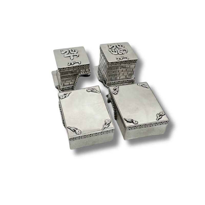 Angled side view of 925 Silver Tefillin Boxes with one lid fully opened, showing interior, engraved lettering, and intricate silver wall design