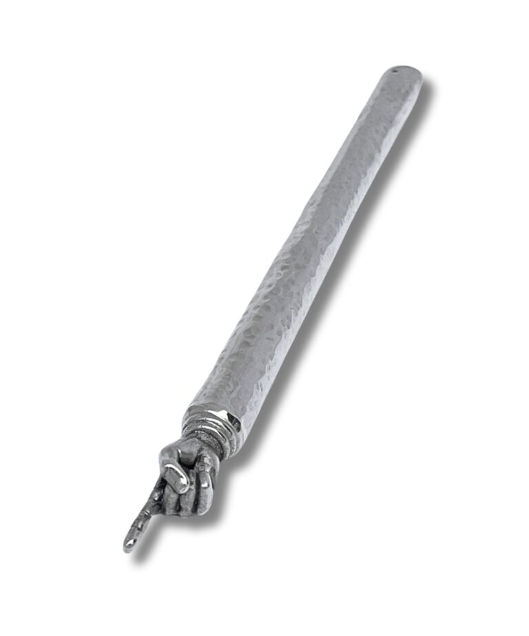 Close-up view of silver Torah pointer with hammered surface and pointed hand detail