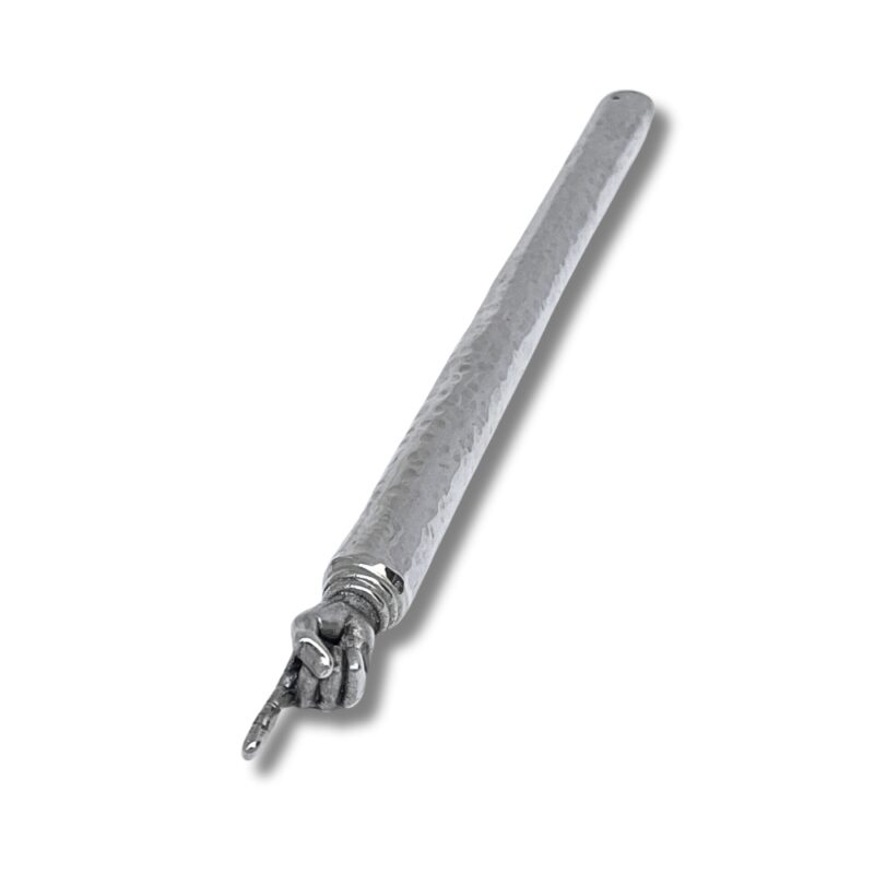 Close-up view of silver Torah pointer with hammered surface and pointed hand detail